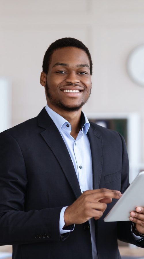 smiling-black-entrepreneur-holding-digital-tablet-office-interior.jpg